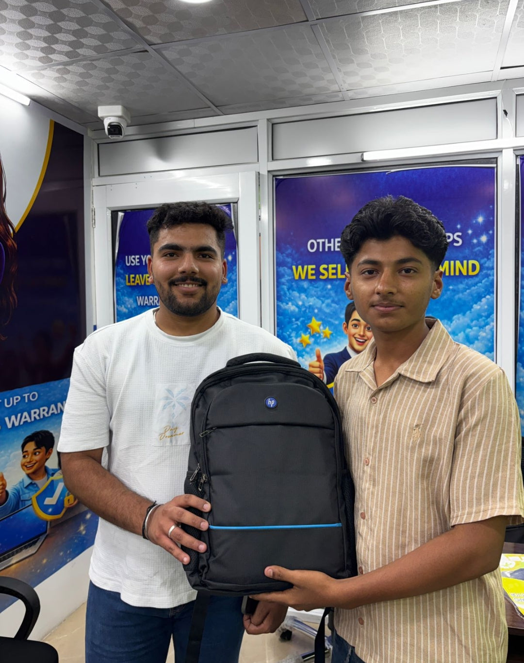 Customers at the NewFeel store with their new laptop