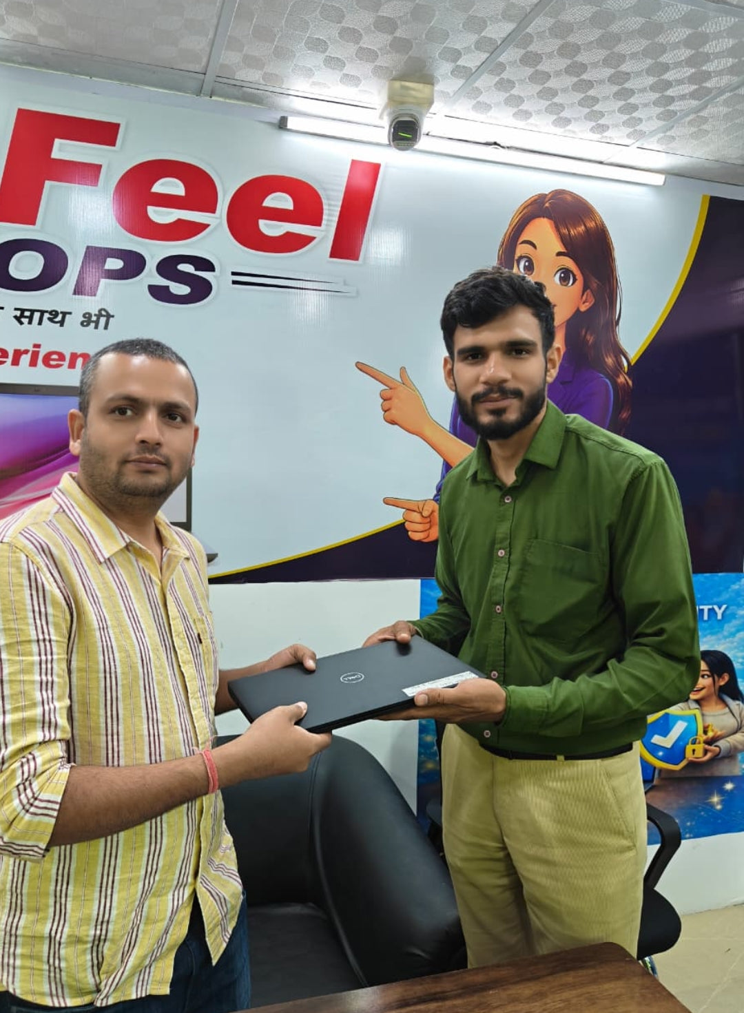 Customers at NewFeel holding a Dell laptop
